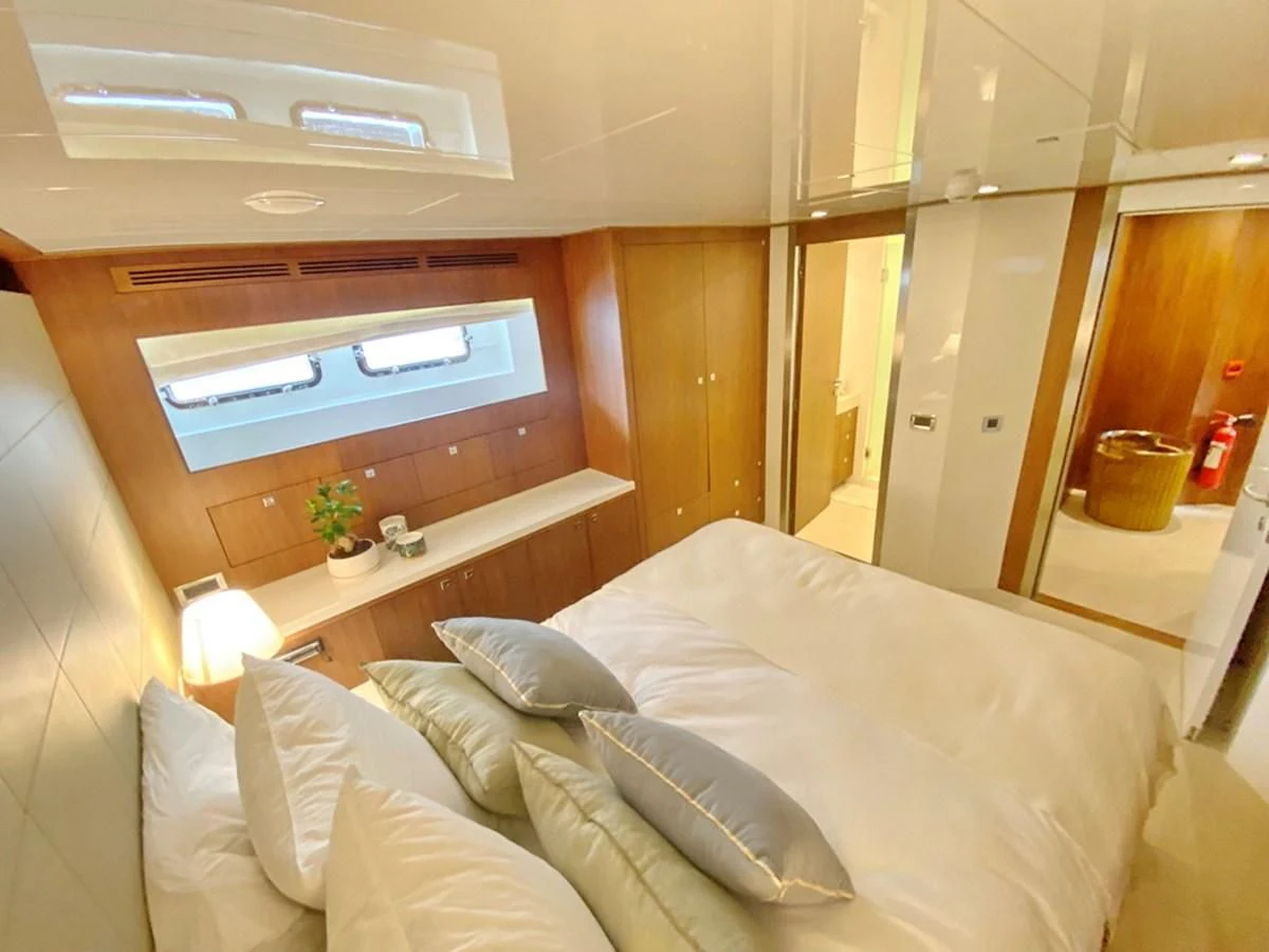 a bed with white sheets aboard O Yacht for Sale