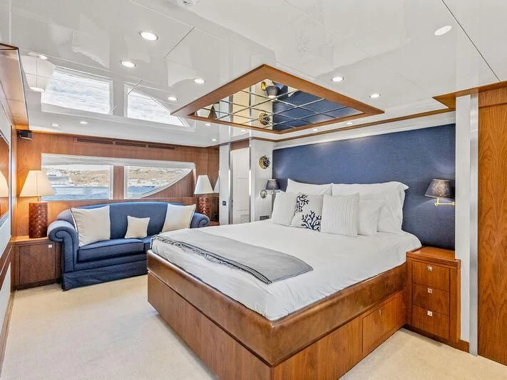 a large bedroom with a bed and a couch aboard O Yacht for Sale