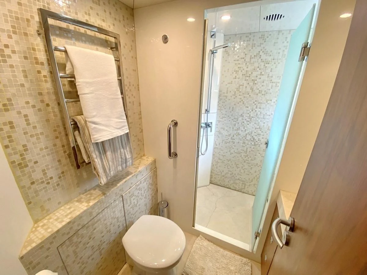 a bathroom with a glass shower door aboard O Yacht for Sale
