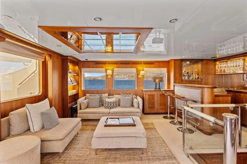 a living room with a couch and a table aboard O Yacht for Sale