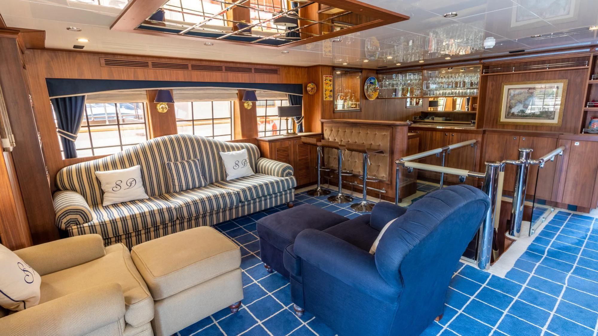a room with couches and a table aboard O Yacht for Sale
