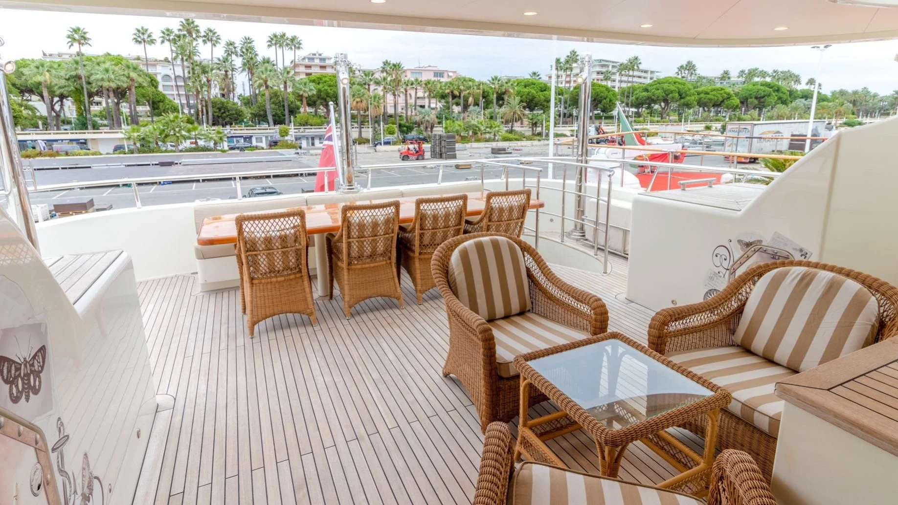 a deck with chairs and tables aboard O Yacht for Sale
