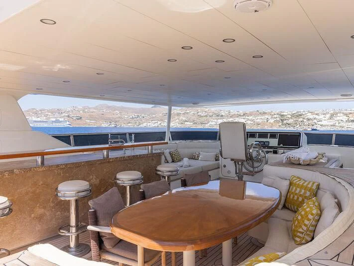 a room with a table and chairs aboard O Yacht for Sale