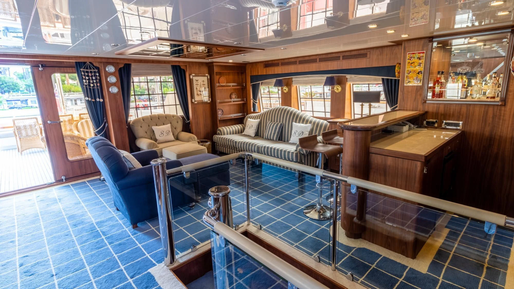a room with a pool table and couches aboard O Yacht for Sale