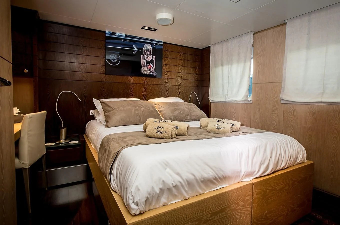 a bed with a white comforter aboard ALTER EGO Yacht for Sale