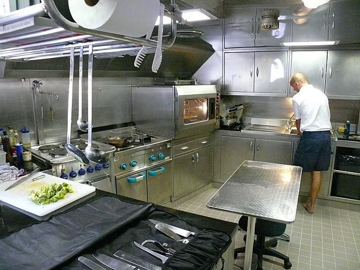 a chef in a kitchen aboard ALTER EGO Yacht for Sale