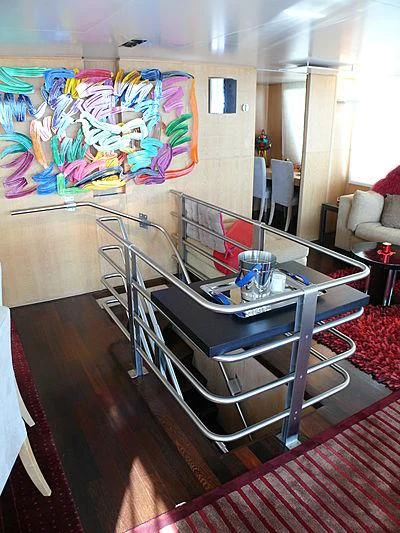 a kitchen with a table and chairs aboard ALTER EGO Yacht for Sale