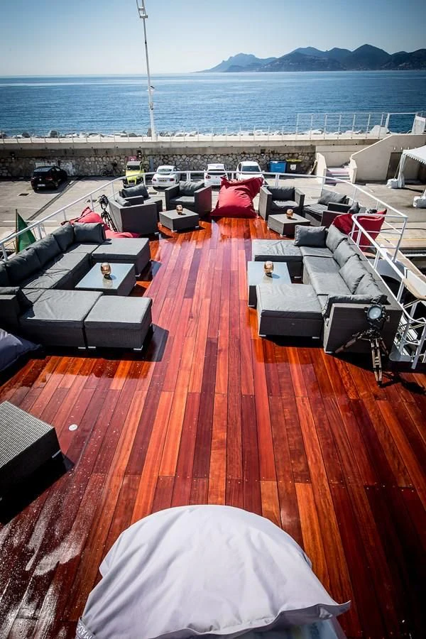 a large orange deck with a beach and a large body of water aboard ALTER EGO Yacht for Sale