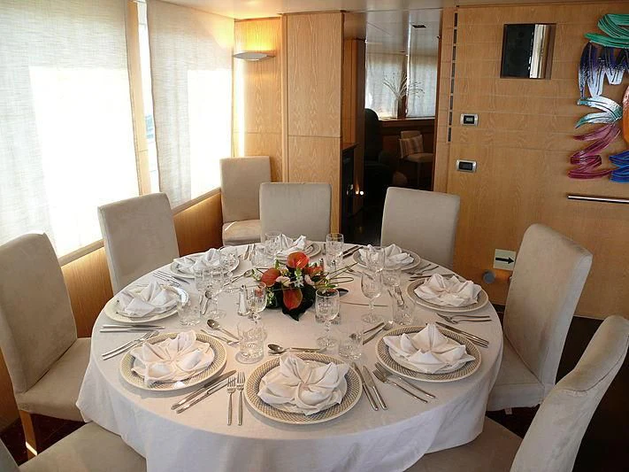 a table set for a formal dinner aboard ALTER EGO Yacht for Sale