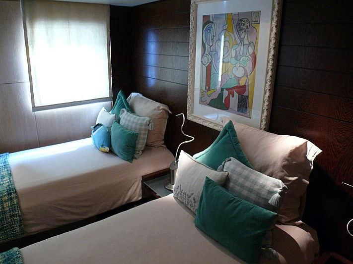 a room with a bed and a painting on the wall aboard ALTER EGO Yacht for Sale