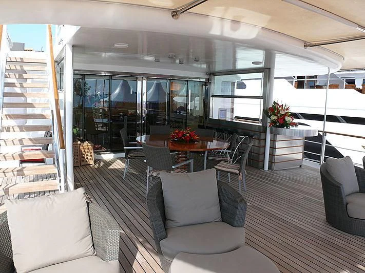 a room with a table chairs and a staircase aboard ALTER EGO Yacht for Sale