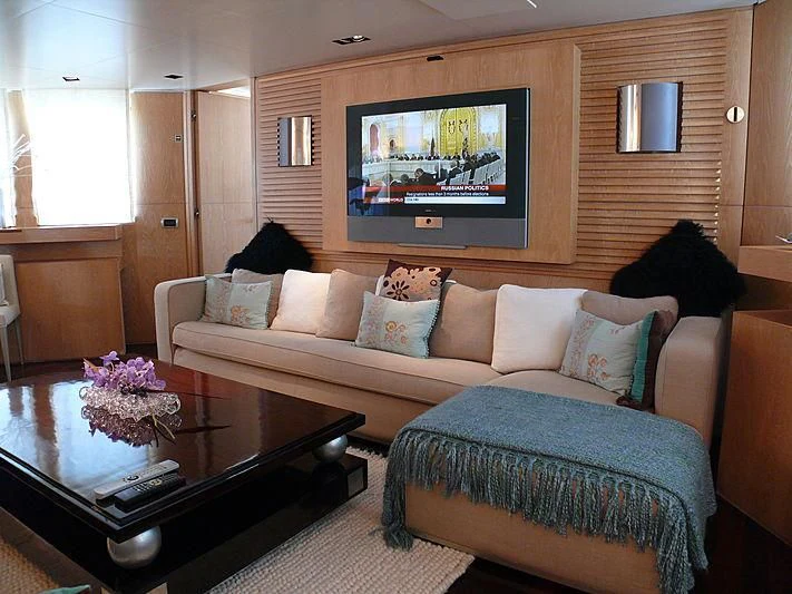 a living room with a couch and a coffee table aboard ALTER EGO Yacht for Sale