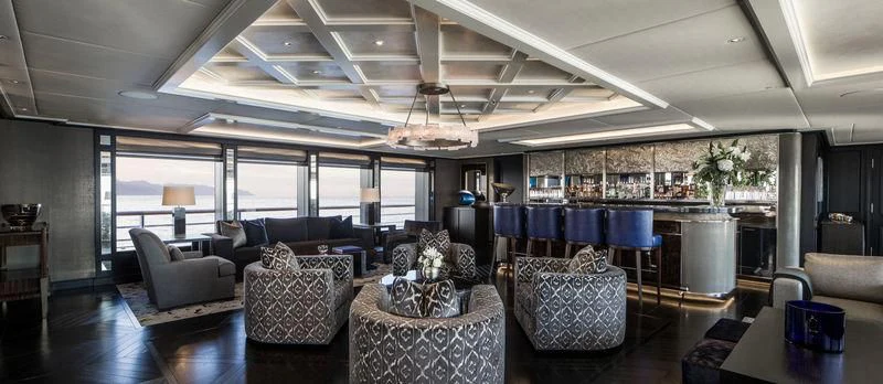a room with a couch and a table and chairs aboard AQUILA Yacht for Sale