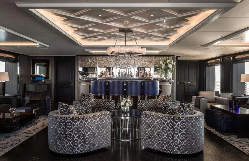 a living room with a large chandelier aboard AQUILA Yacht for Sale
