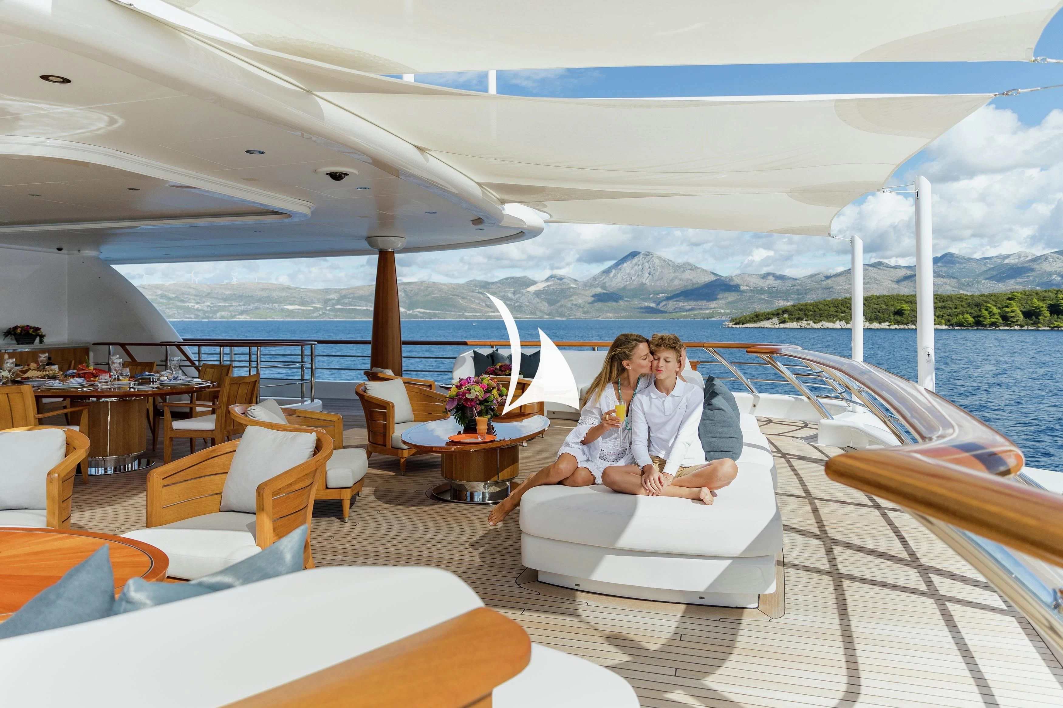 a couple sitting on a yacht aboard AQUILA Yacht for Sale