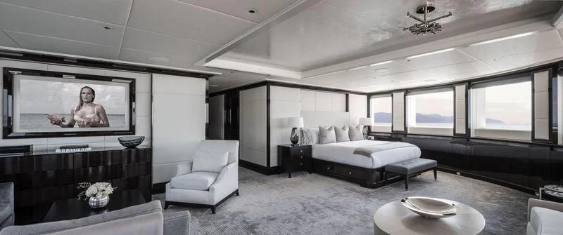 a large room with a bed and a television aboard AQUILA Yacht for Sale