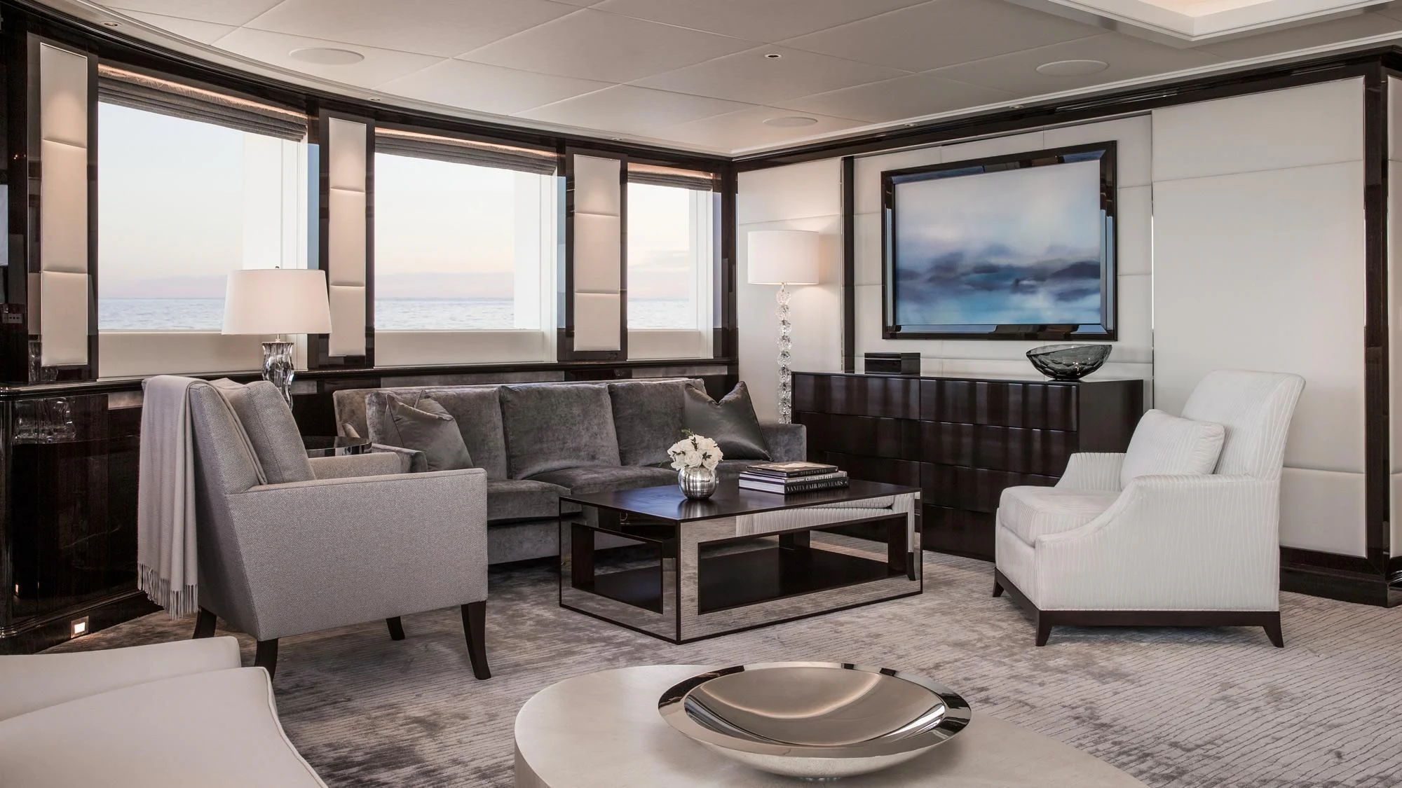 a living room with a large screen aboard AQUILA Yacht for Sale
