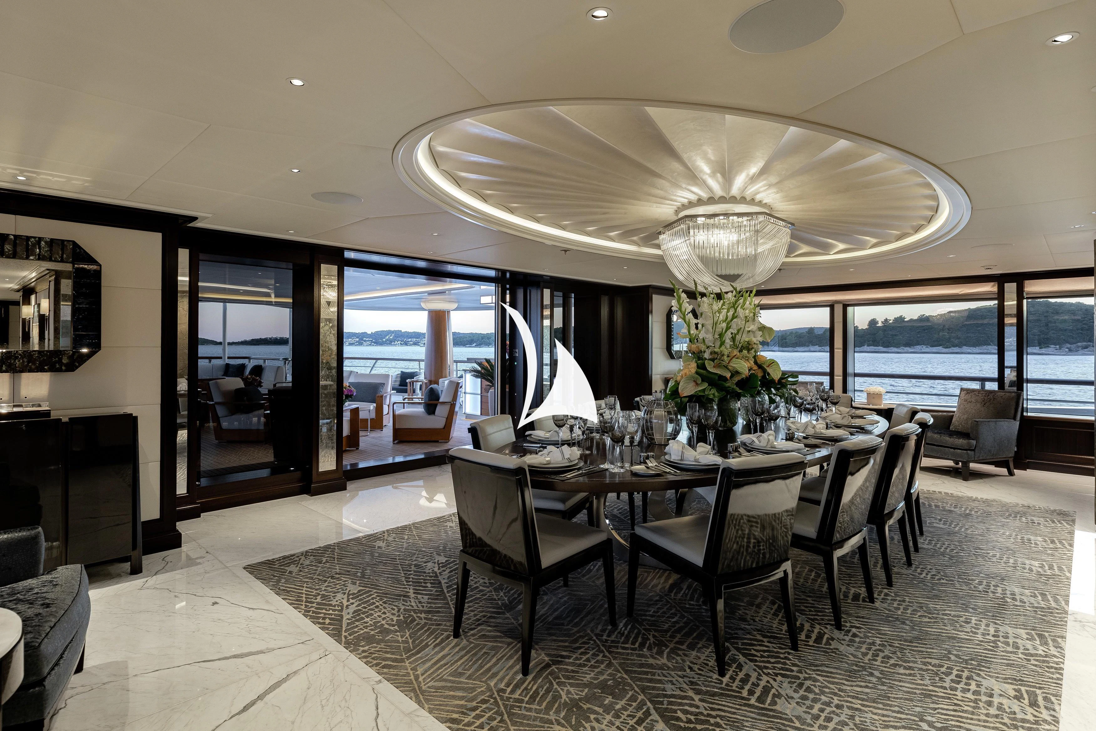a large room with a table and chairs aboard AQUILA Yacht for Sale