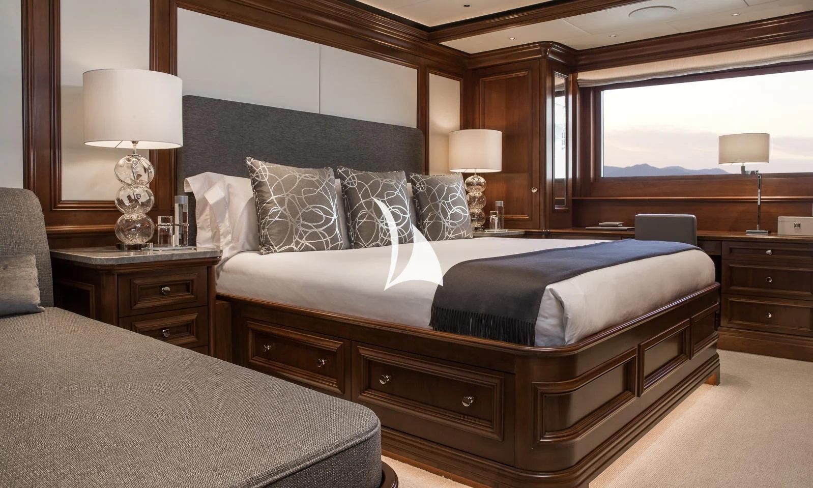 a bedroom with a bed and a lamp aboard AQUILA Yacht for Sale