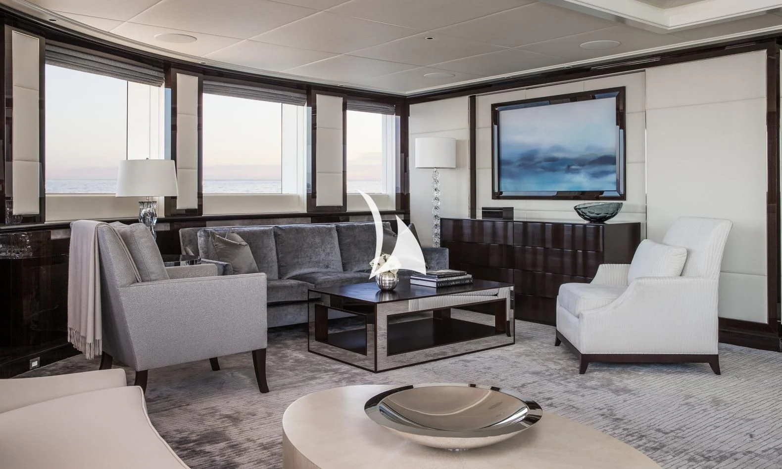 a living room with a large screen aboard AQUILA Yacht for Sale