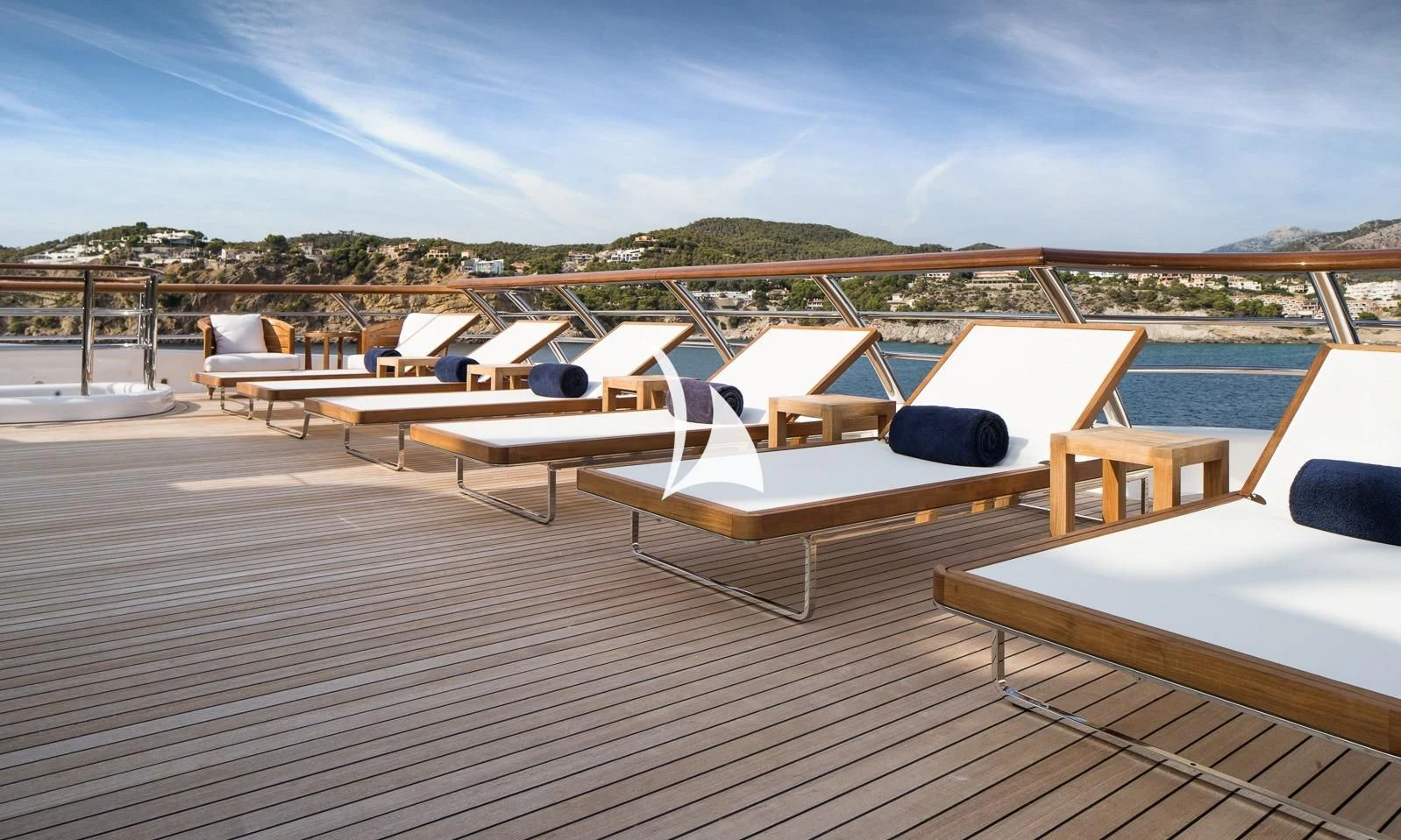 a deck with many lounge chairs aboard AQUILA Yacht for Sale