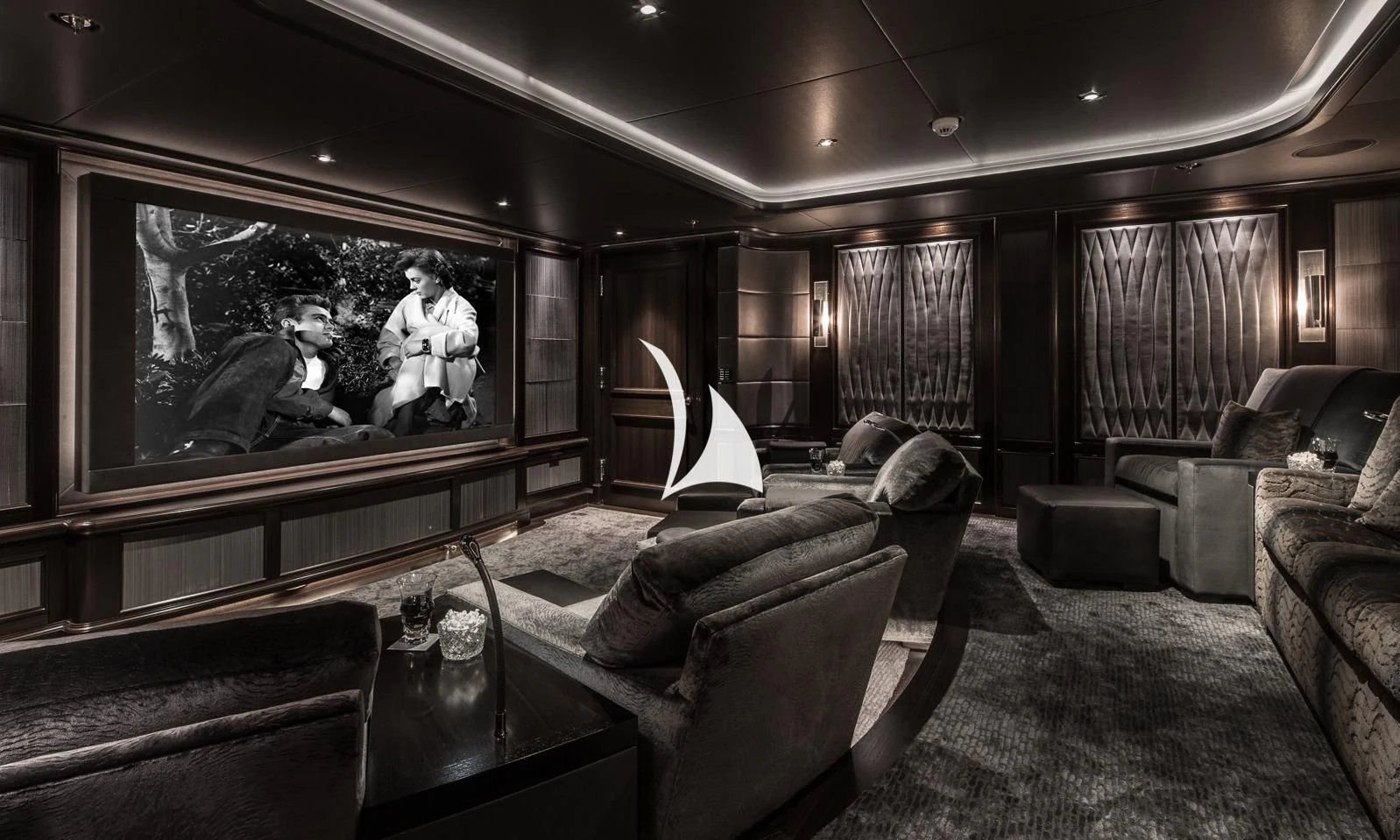 a living room with a tv and couches aboard AQUILA Yacht for Sale