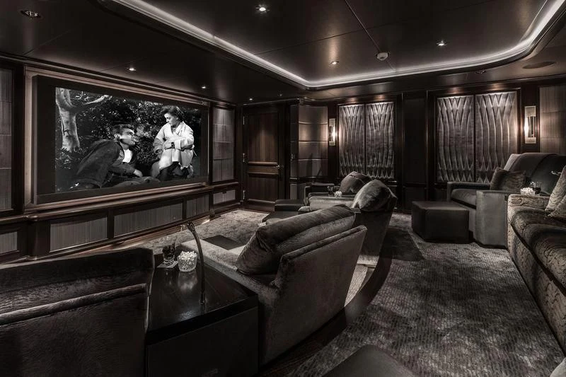 a living room with a large screen aboard AQUILA Yacht for Sale