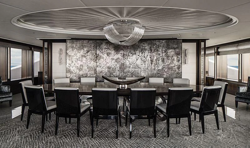 a large room with chairs and a table and a large chandelier aboard AQUILA Yacht for Sale