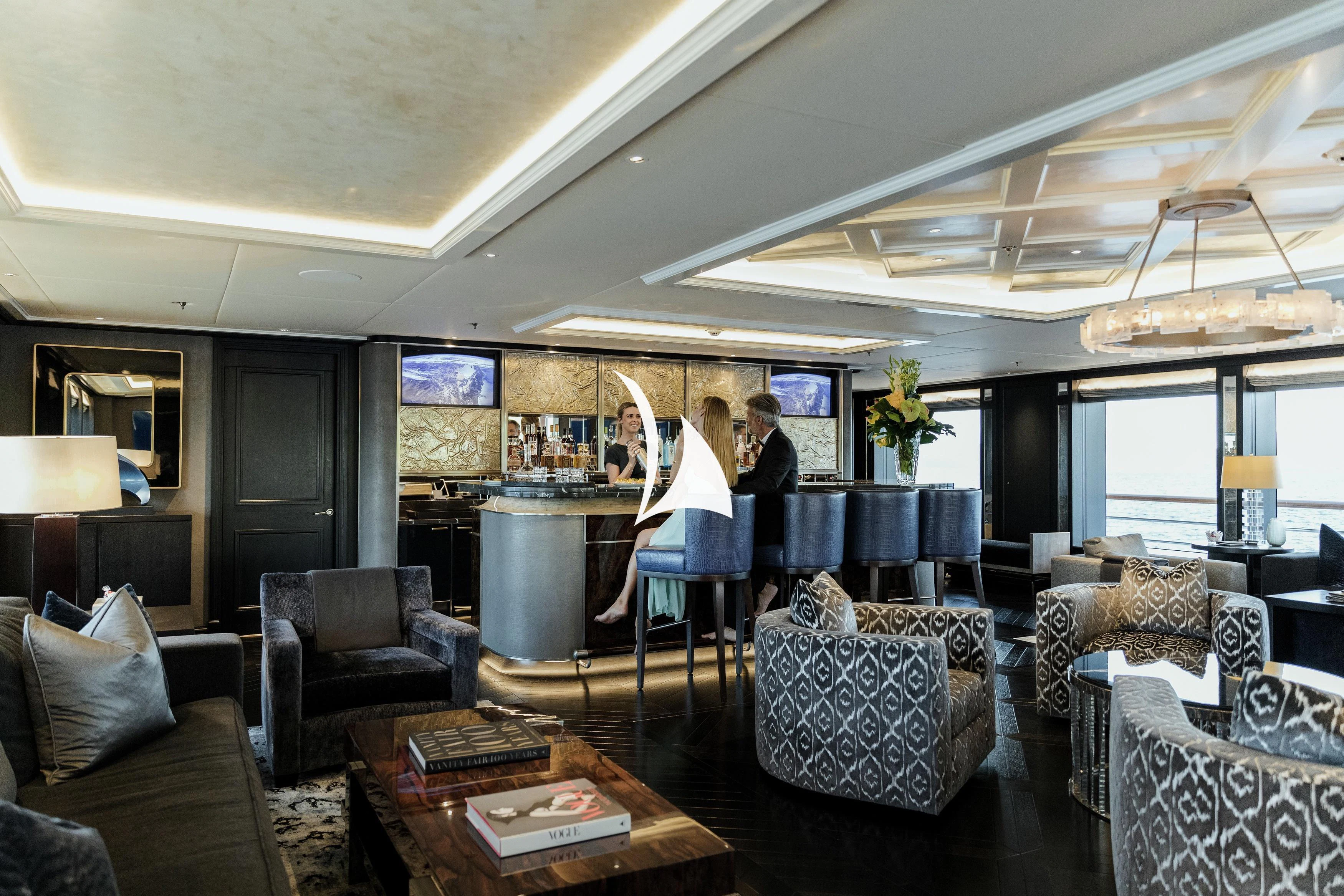 a couple of people in a living room aboard AQUILA Yacht for Sale