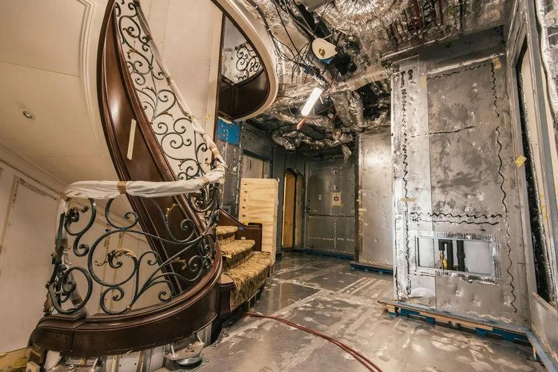 a room with a chandelier and a clock aboard AQUILA Yacht for Sale