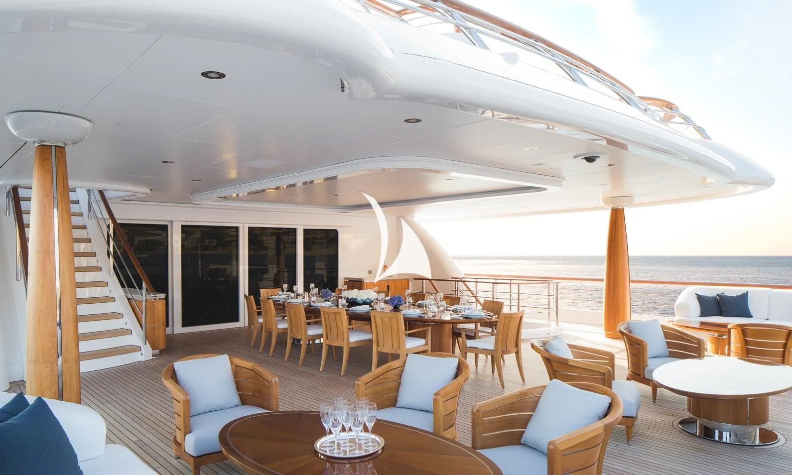 a large living room with a staircase aboard AQUILA Yacht for Sale