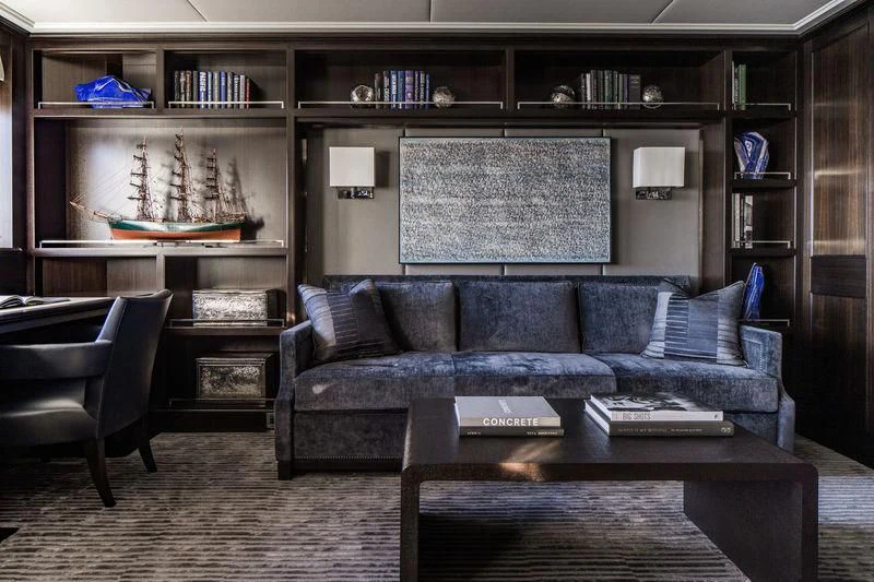 a living room with a couch and a table aboard AQUILA Yacht for Sale