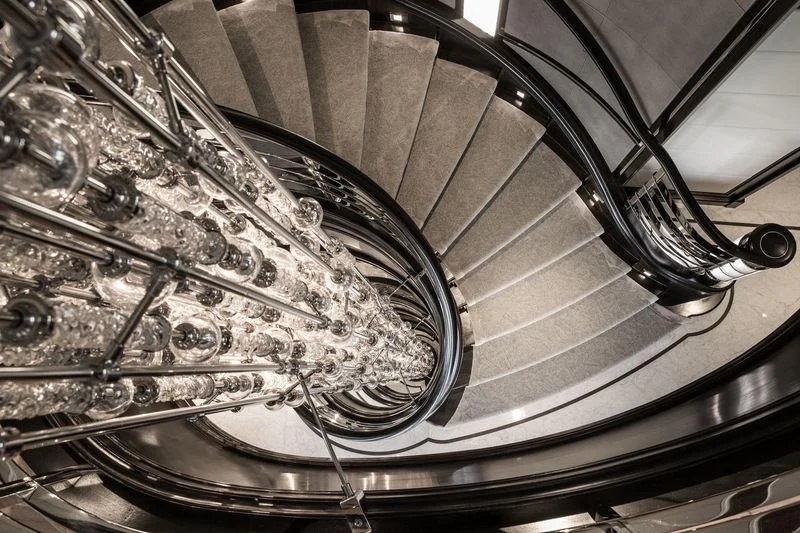 a spiral staircase with a spiral staircase aboard AQUILA Yacht for Sale