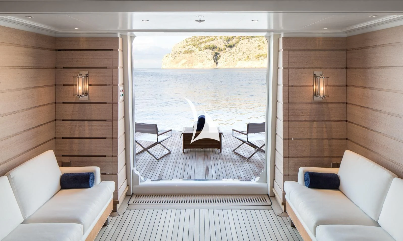 a room with a couch and a table and a view of the water aboard AQUILA Yacht for Sale