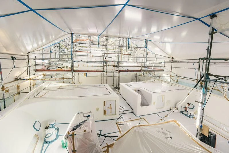 a room with white walls and blue wires aboard AQUILA Yacht for Sale