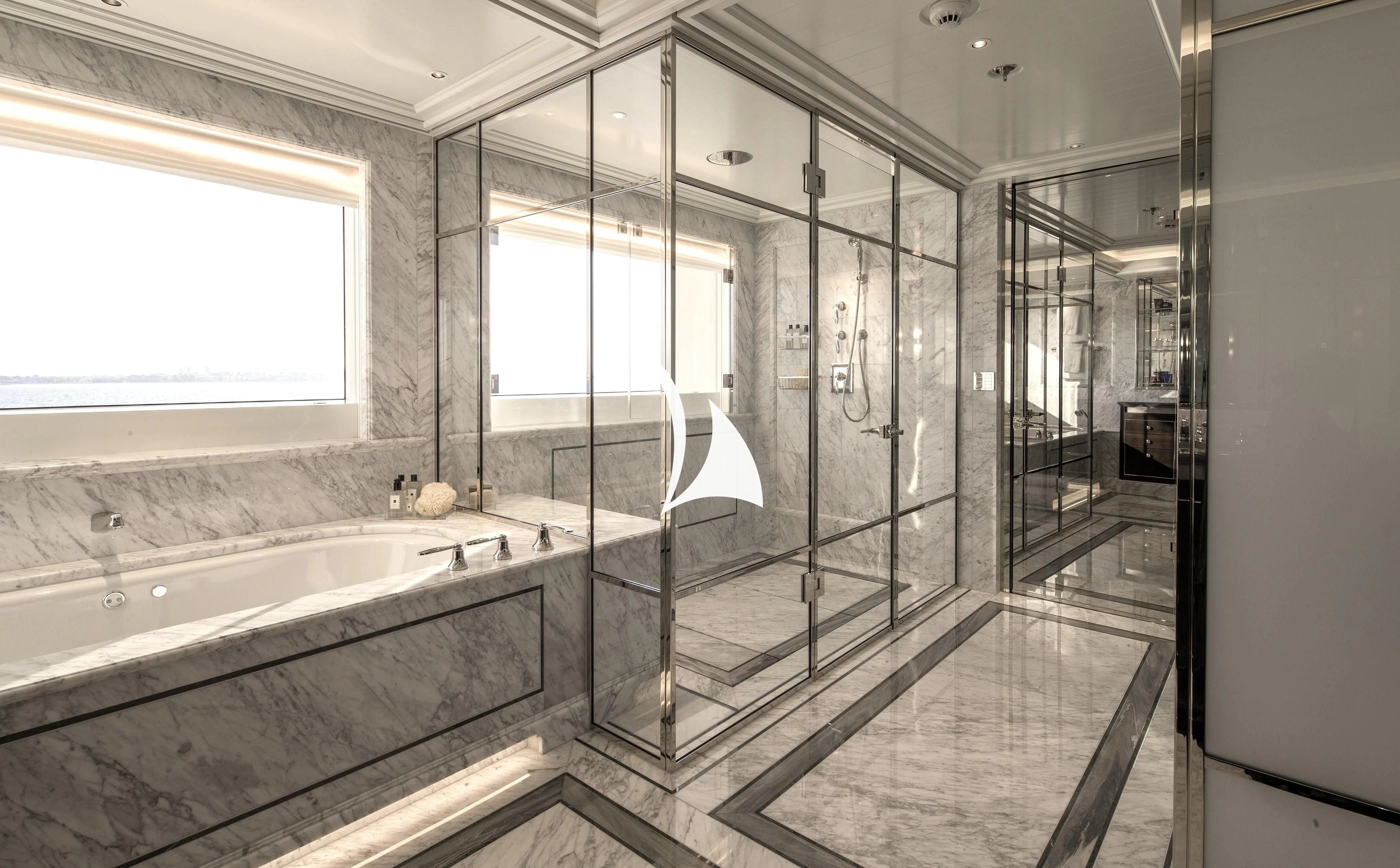 a bathroom with a tub and shower aboard AQUILA Yacht for Sale