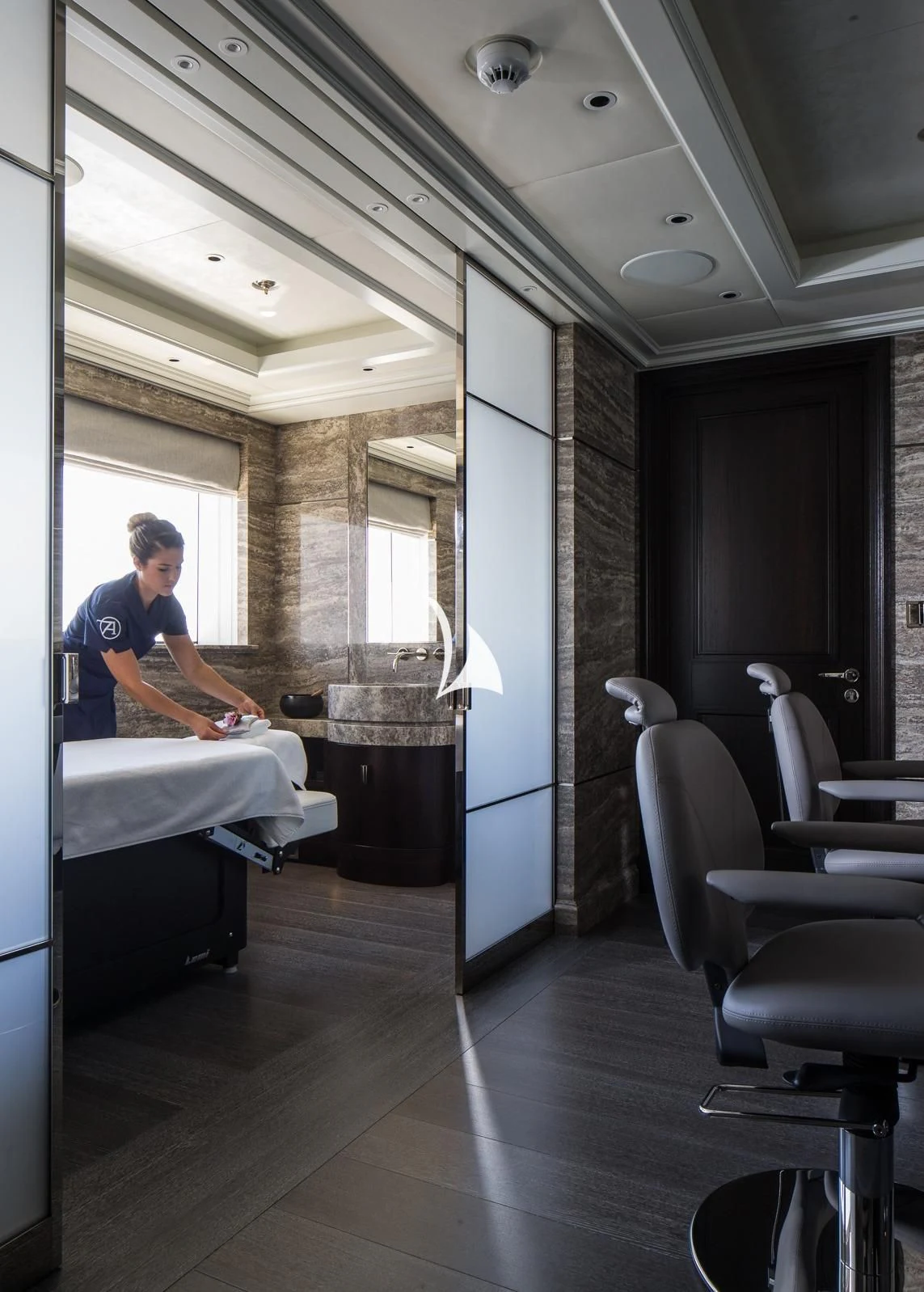 a man sitting in a room aboard AQUILA Yacht for Sale