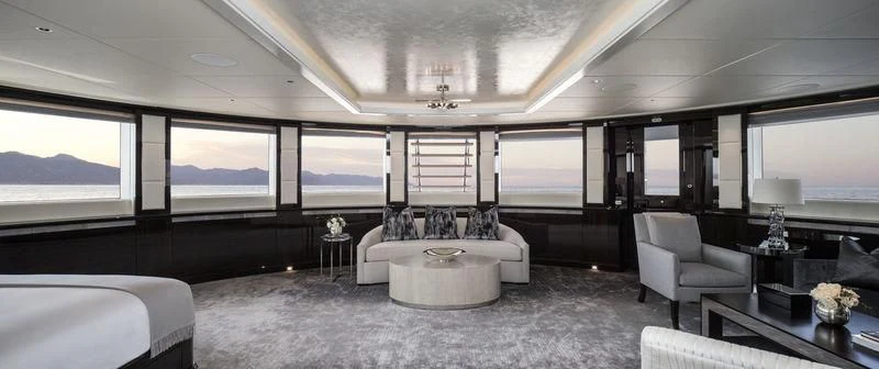 a room with a bed and a table aboard AQUILA Yacht for Sale