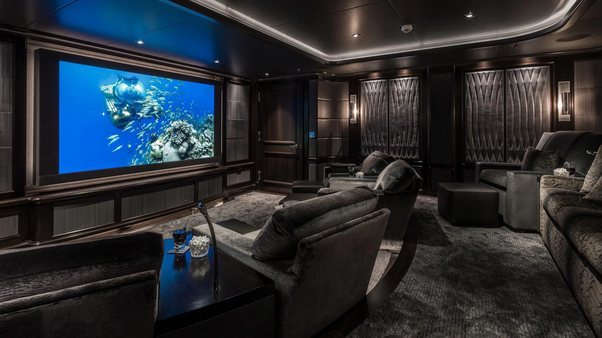 a living room with a large screen aboard AQUILA Yacht for Sale