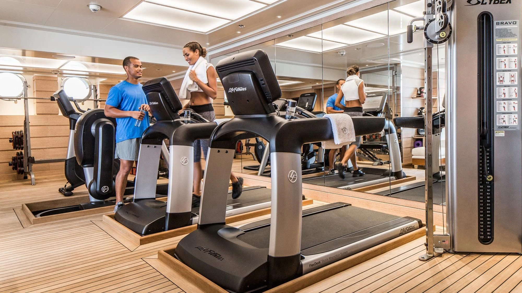 people working in a gym aboard AQUILA Yacht for Sale