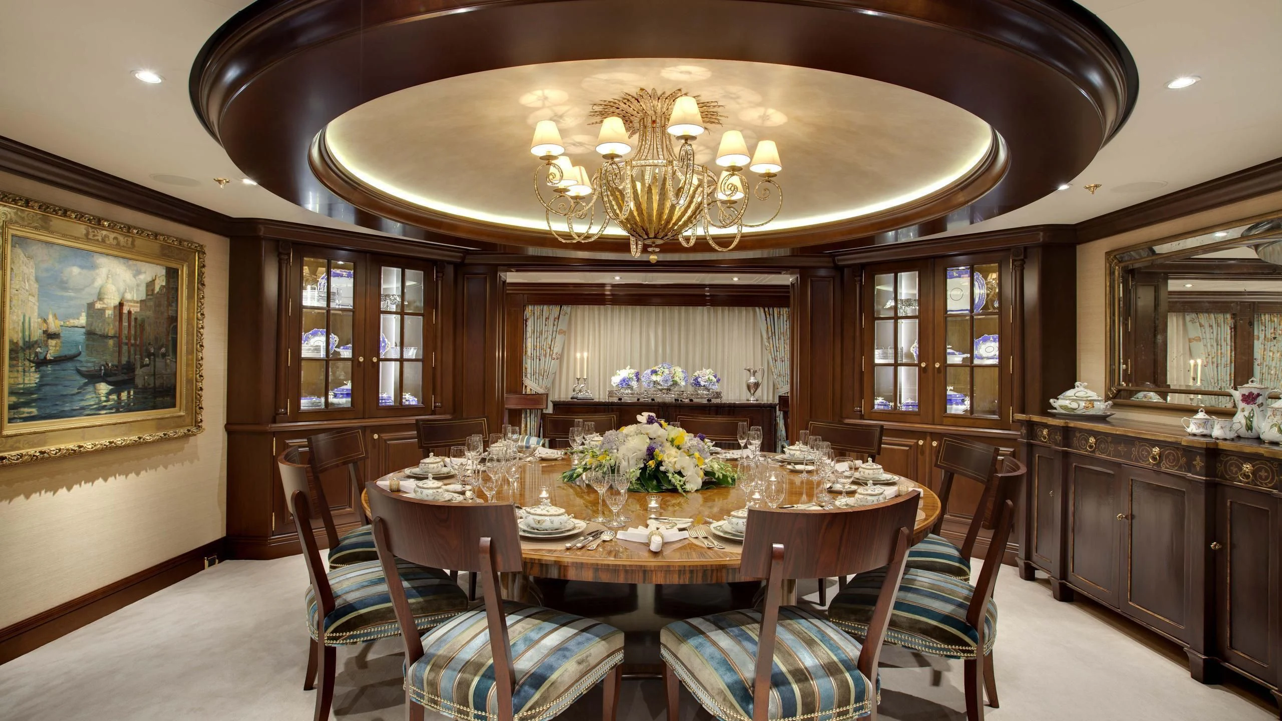 a dining room with a chandelier above it aboard AQUILA Yacht for Sale