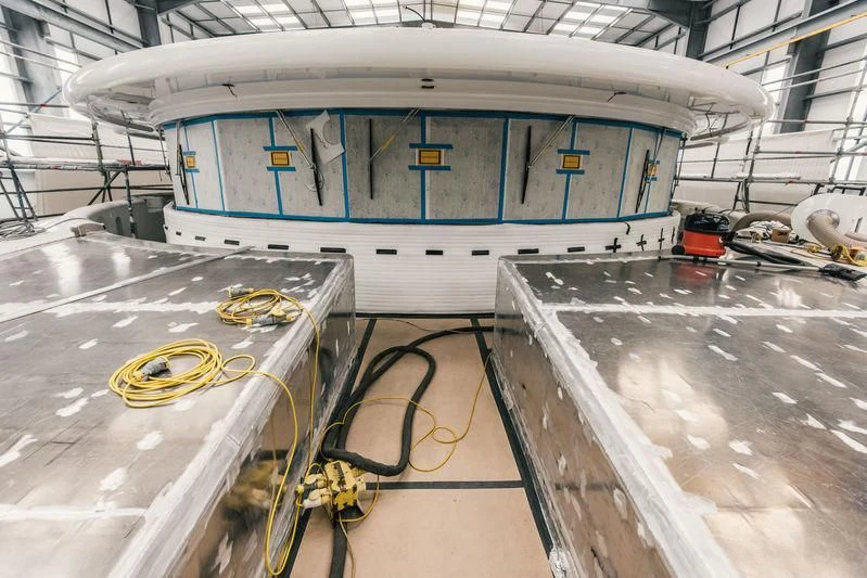 a blue and white train inside a building aboard AQUILA Yacht for Sale