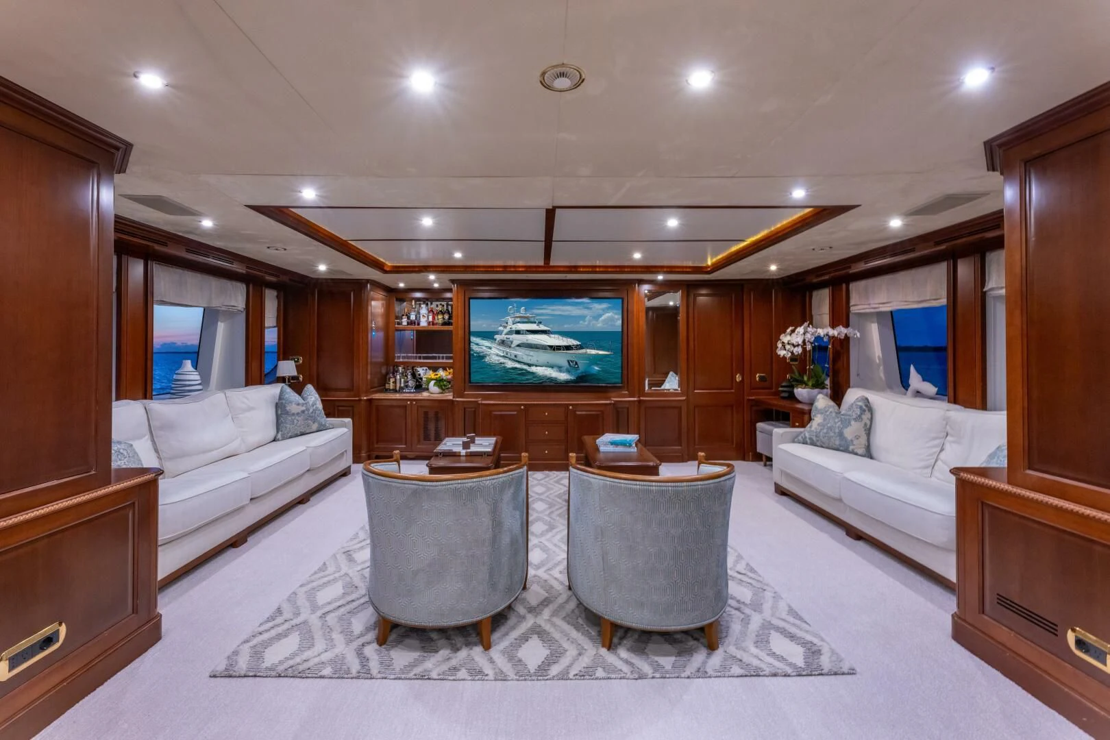 a living room with a large television aboard NAMASTE Yacht for Sale