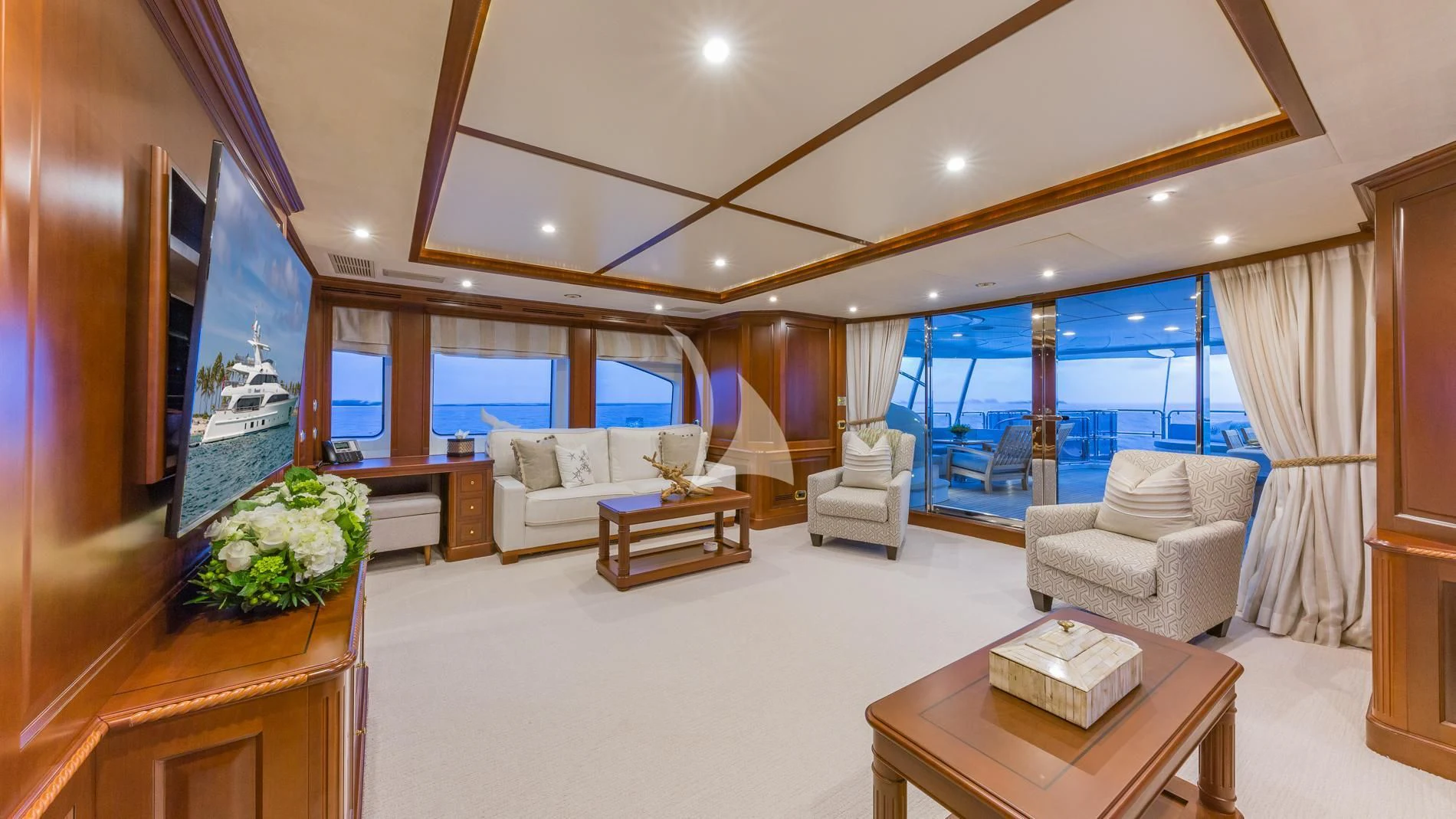 a living room with a large screen aboard NAMASTE Yacht for Sale