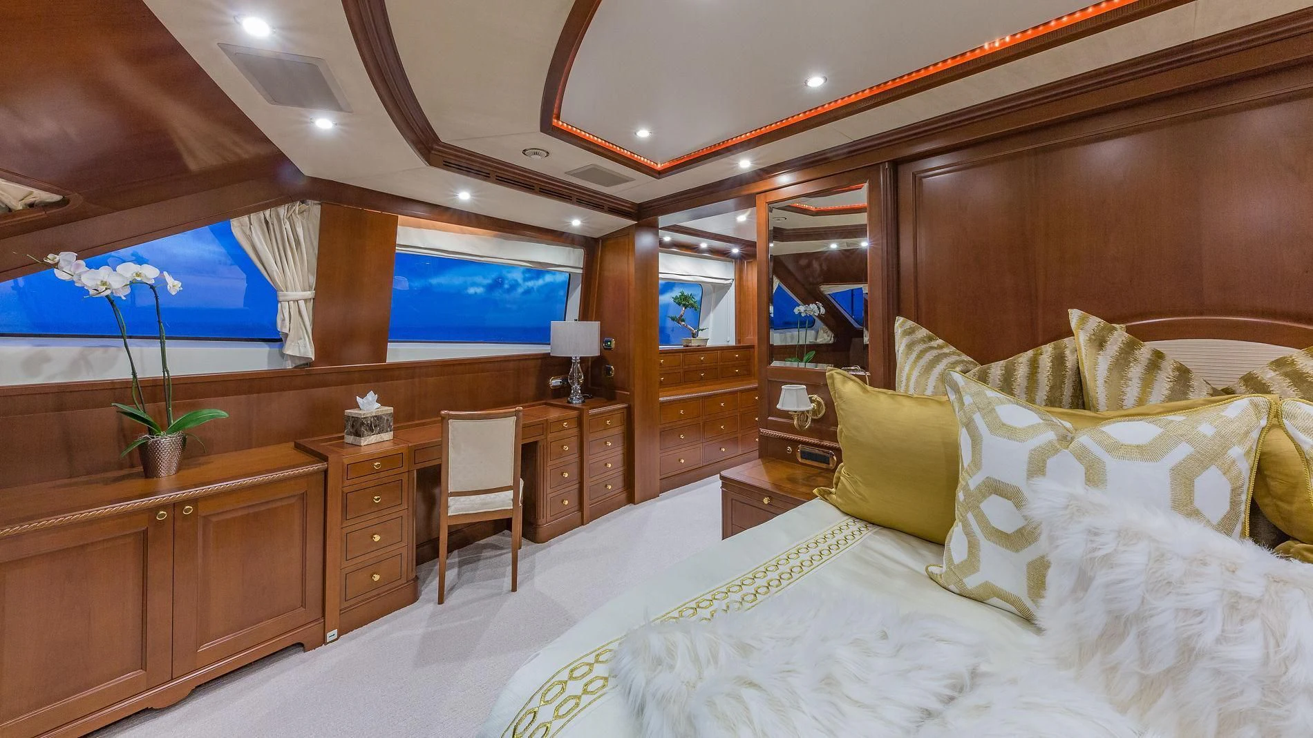 a bed with a white bed spread aboard NAMASTE Yacht for Sale