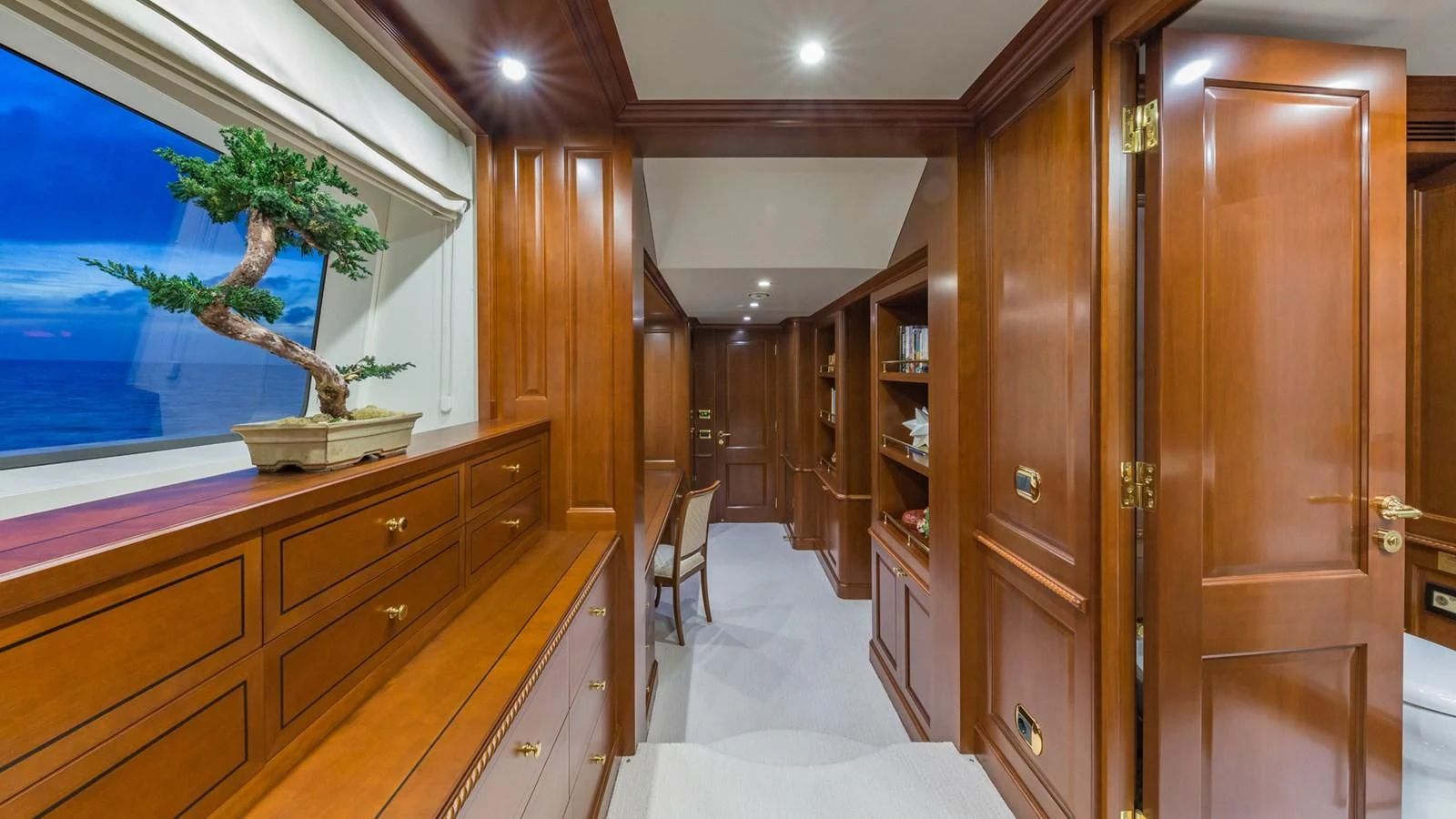 a room with wooden cabinets and a painting on the wall aboard NAMASTE Yacht for Sale