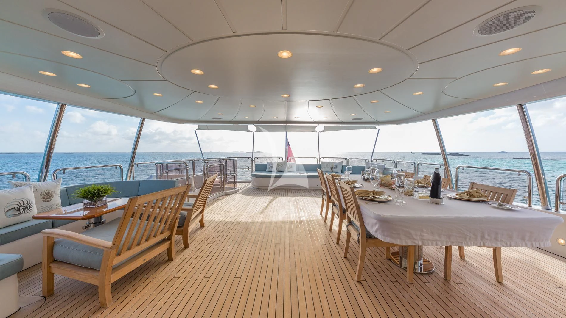 a room with tables and chairs aboard NAMASTE Yacht for Sale