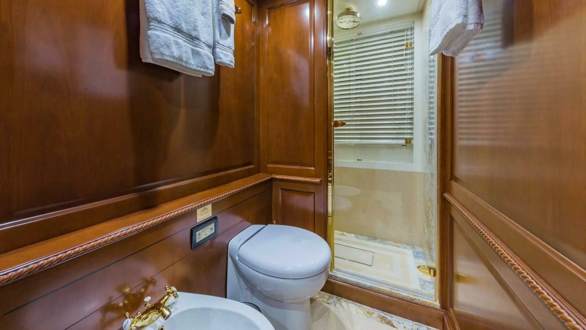 a bathroom with a toilet and a sink aboard NAMASTE Yacht for Sale