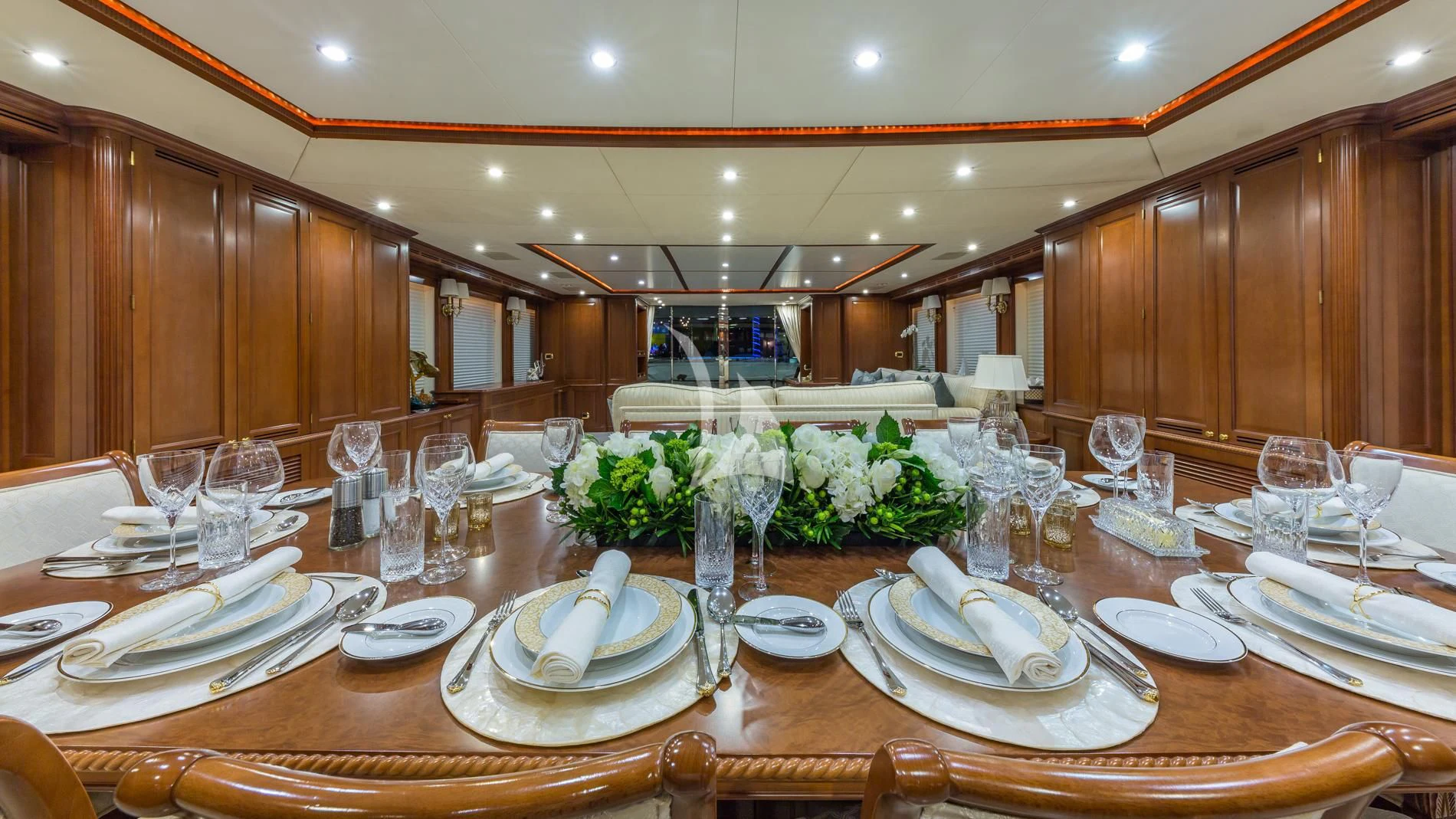 a large table with plates and glasses aboard NAMASTE Yacht for Sale