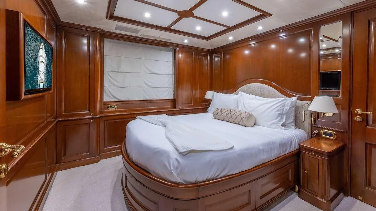a room with a bed and a desk aboard NAMASTE Yacht for Sale